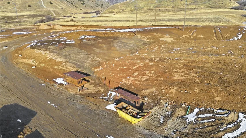 Snowy aerial view with a mountain view and a view of rural / pastoral area