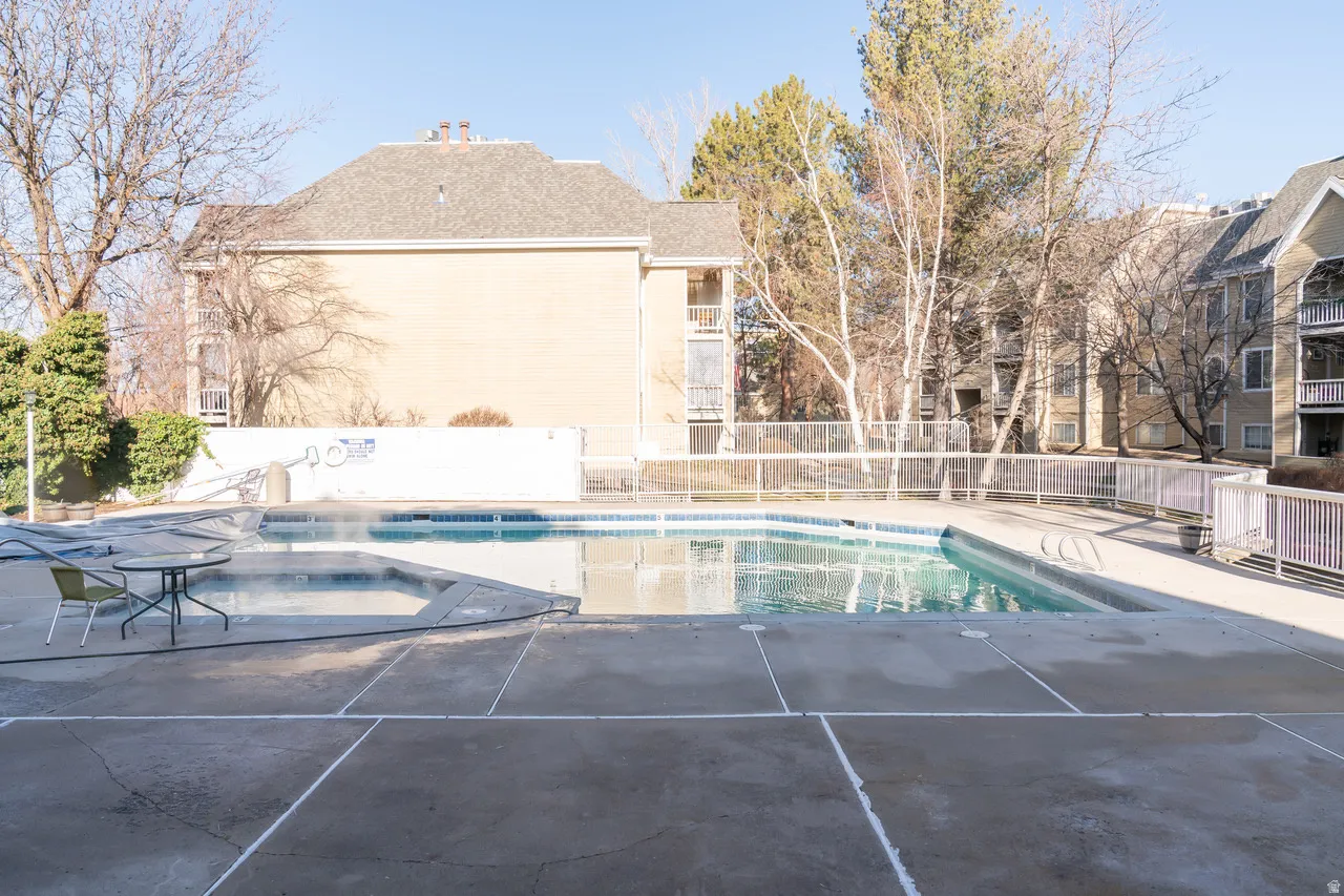 Pool for HOA members and guests featuring a delightful patio and a hot tub.