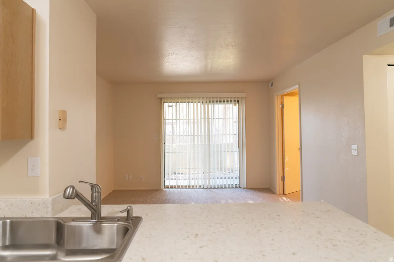 Looking toward the sliding glass doors to the patio complete with tasteful window partitions.