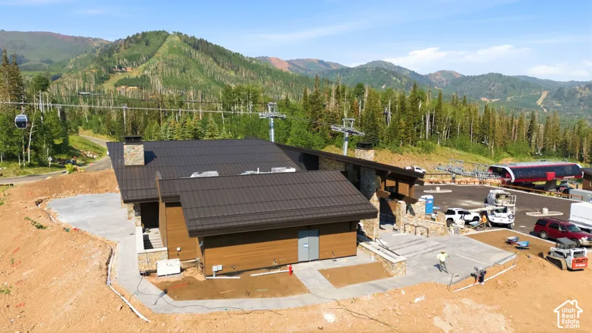 Modern mountain-style structure featuring a metal roof and stone accents