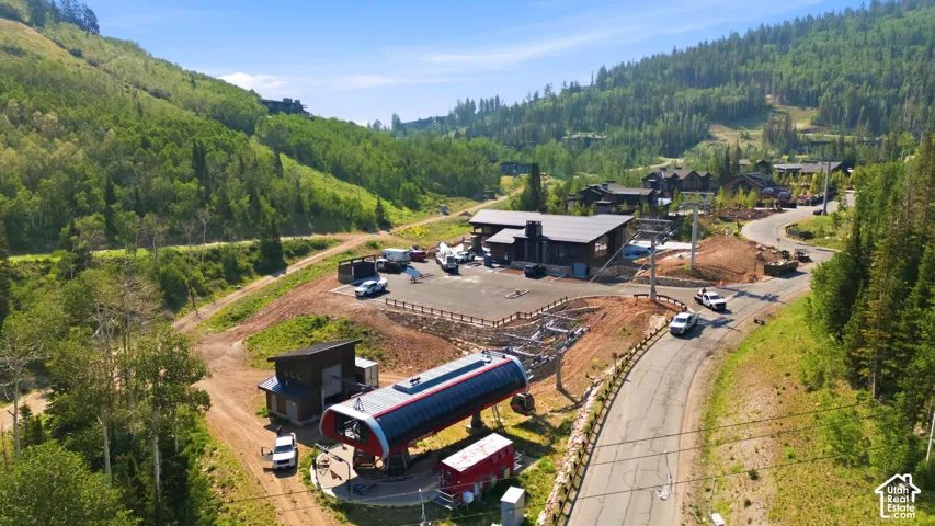 Ski lift station with surrounding wooded hillsides and partially paved roads