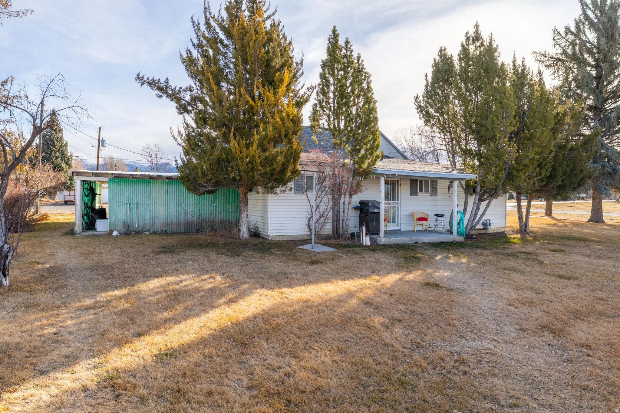 Rear view of property with a patio and a lawn