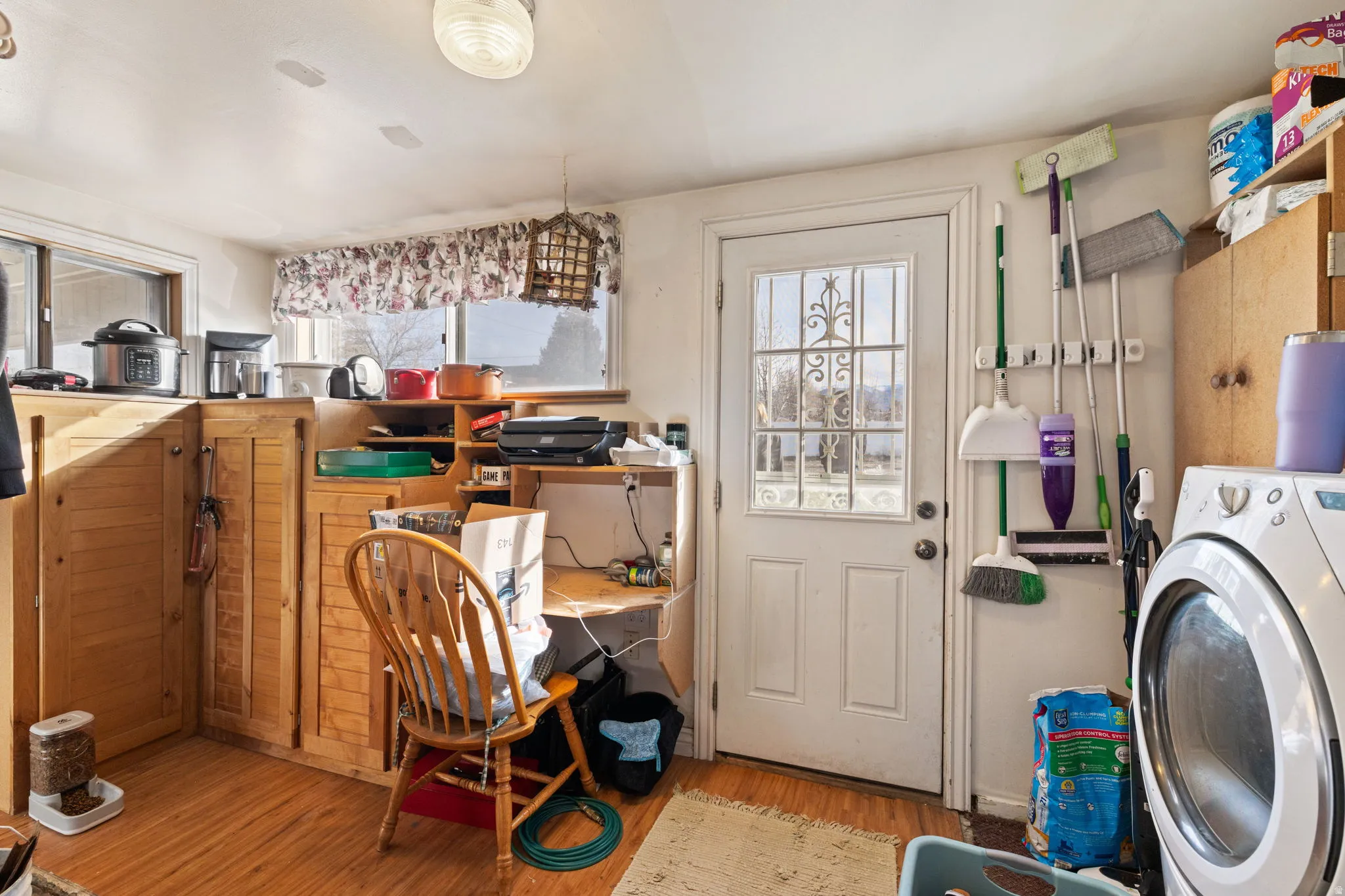 Laundry area with washer / clothes dryer, light wood-style flooring, and plenty of natural light