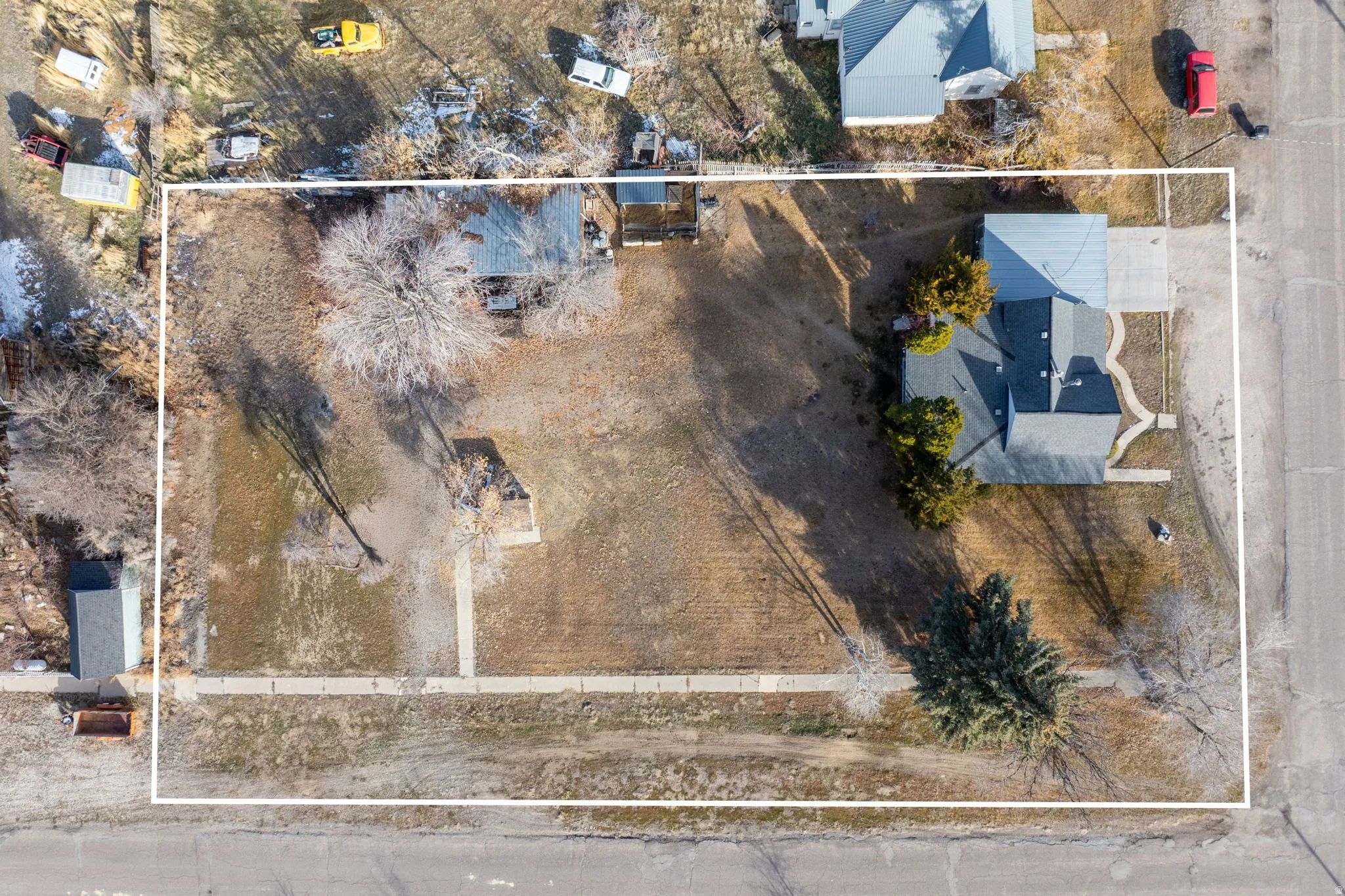 Aerial view of property and surrounding area with property parcel outlined