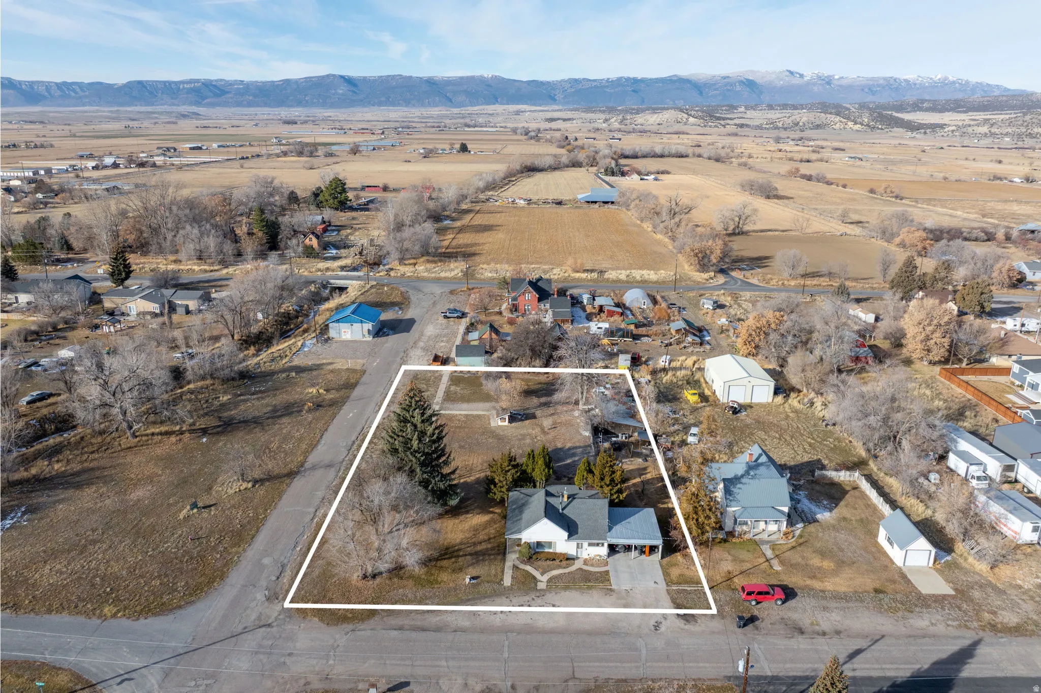 View of rural area featuring nearby suburban area and property boundaries highlighted