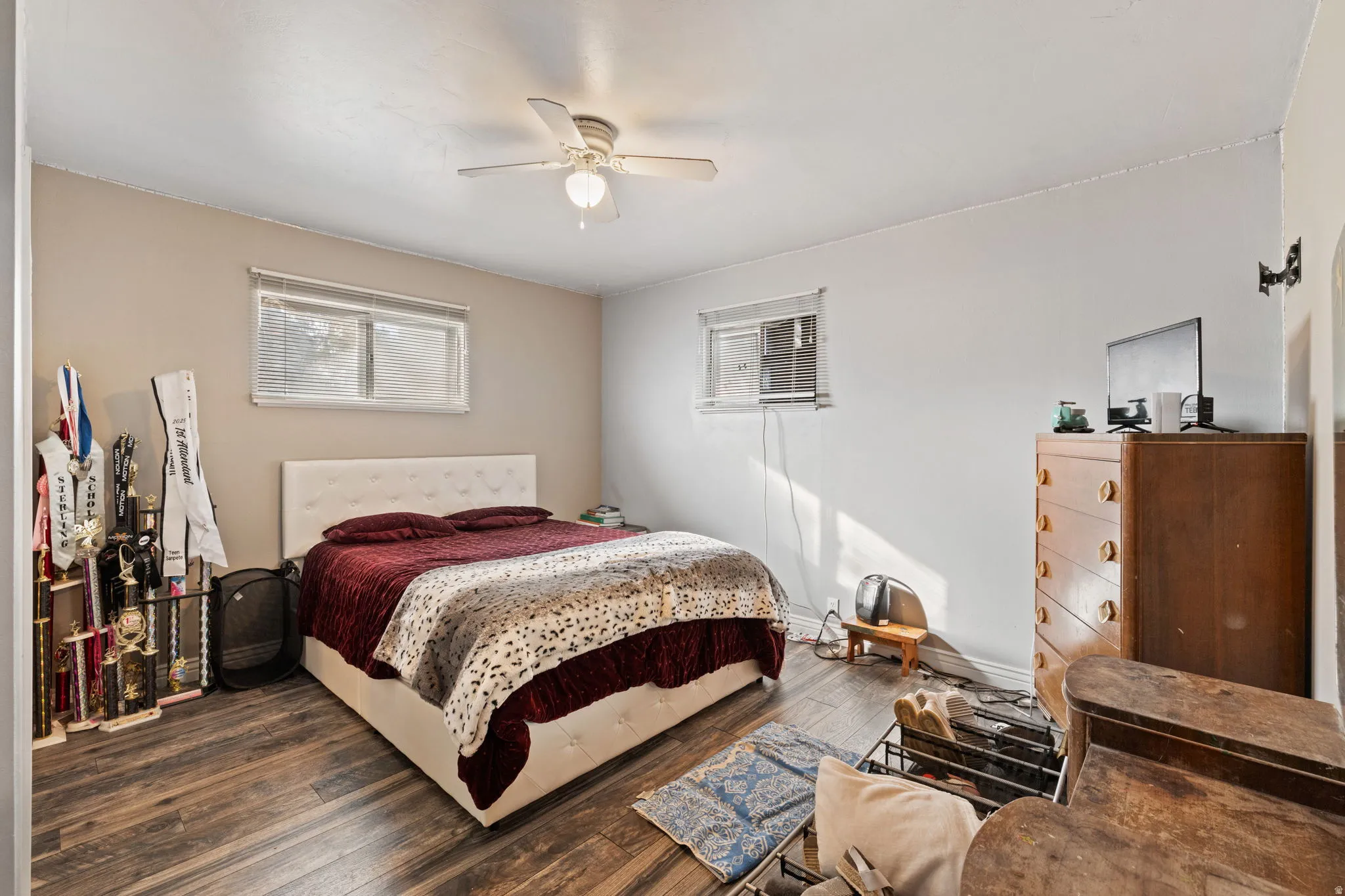 Bedroom featuring dark wood-type flooring and ceiling fan