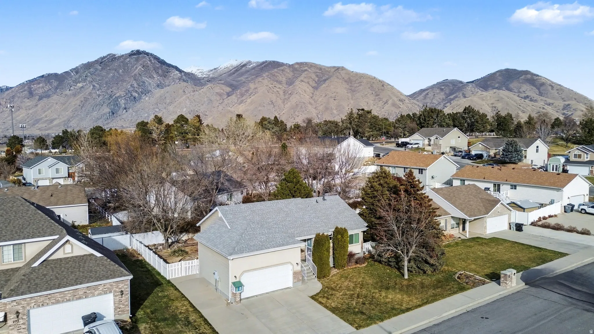 View of mountain backdrop featuring nearby suburban area