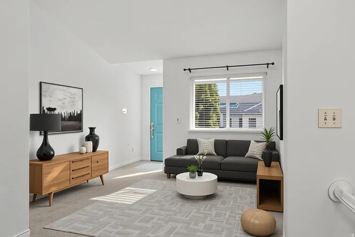 Carpeted living area with baseboards