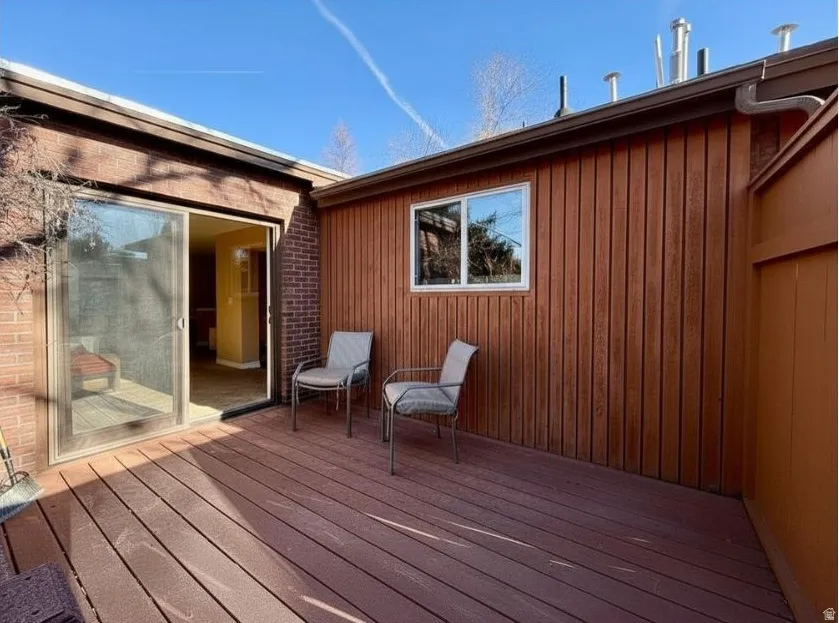 View of deck and access to dining and kitchen