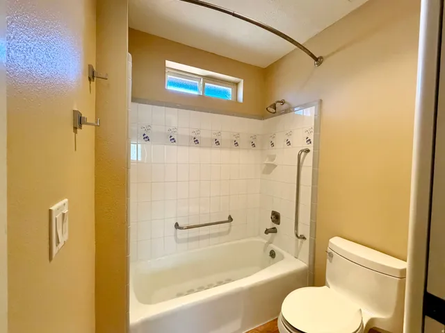 Full bathroom featuring shower / bath combination and toilet