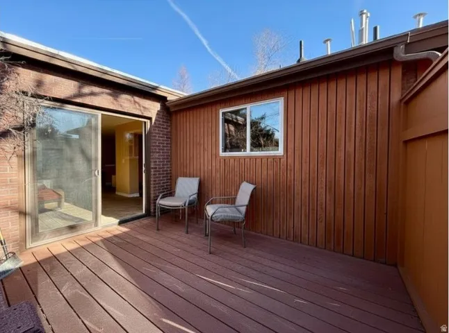 View of deck and access to dining and kitchen