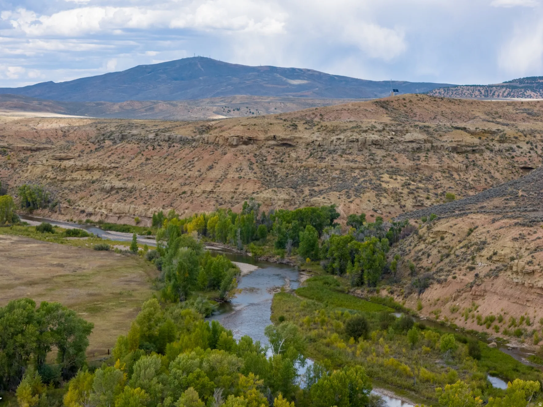 Mountain view with a nearby body of water and rural landscape