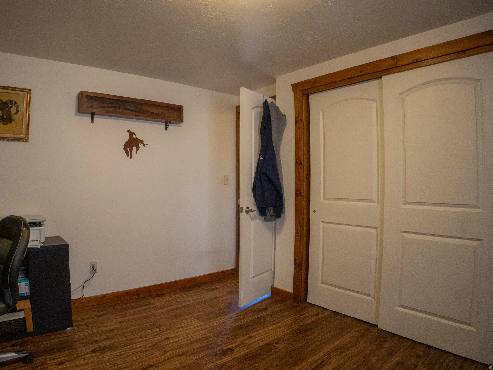 Office space with dark wood finished floors and a textured ceiling