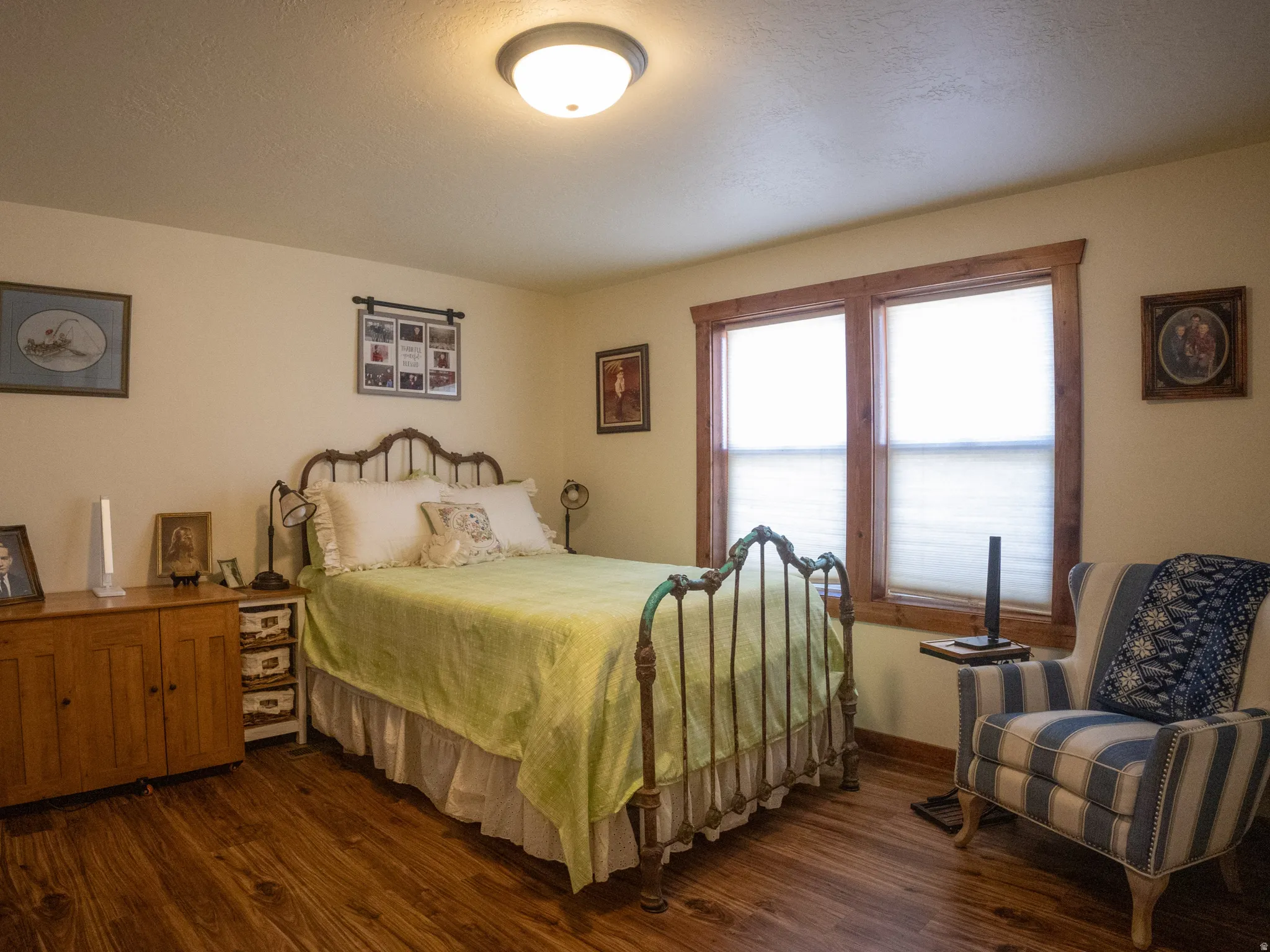 Bedroom featuring dark wood finished floors and a textured ceiling