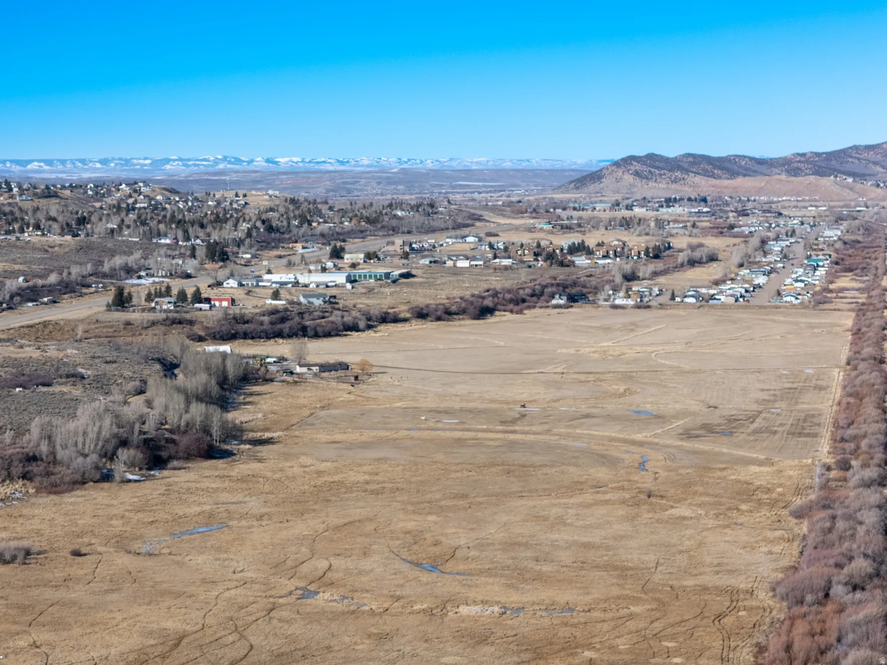 Aerial view of property's location with a mountainous background and rural landscape