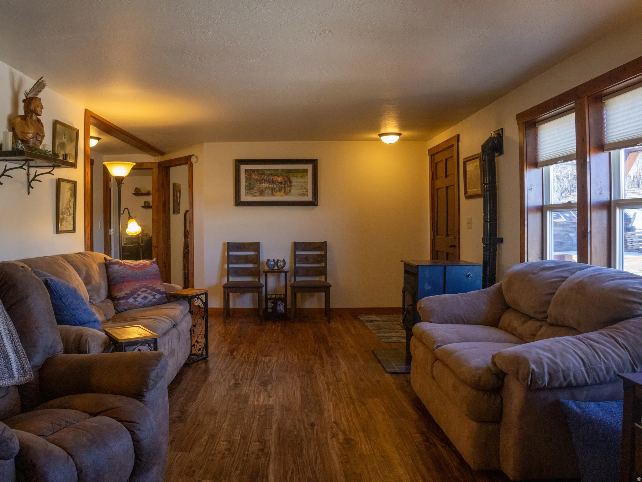 Living room featuring dark wood-style floors and a textured ceiling