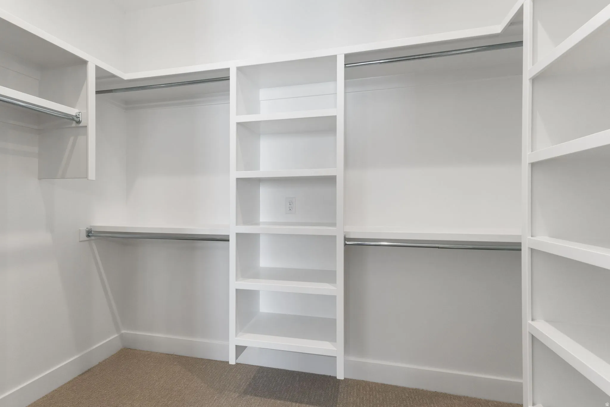 Walk in closet with light carpet