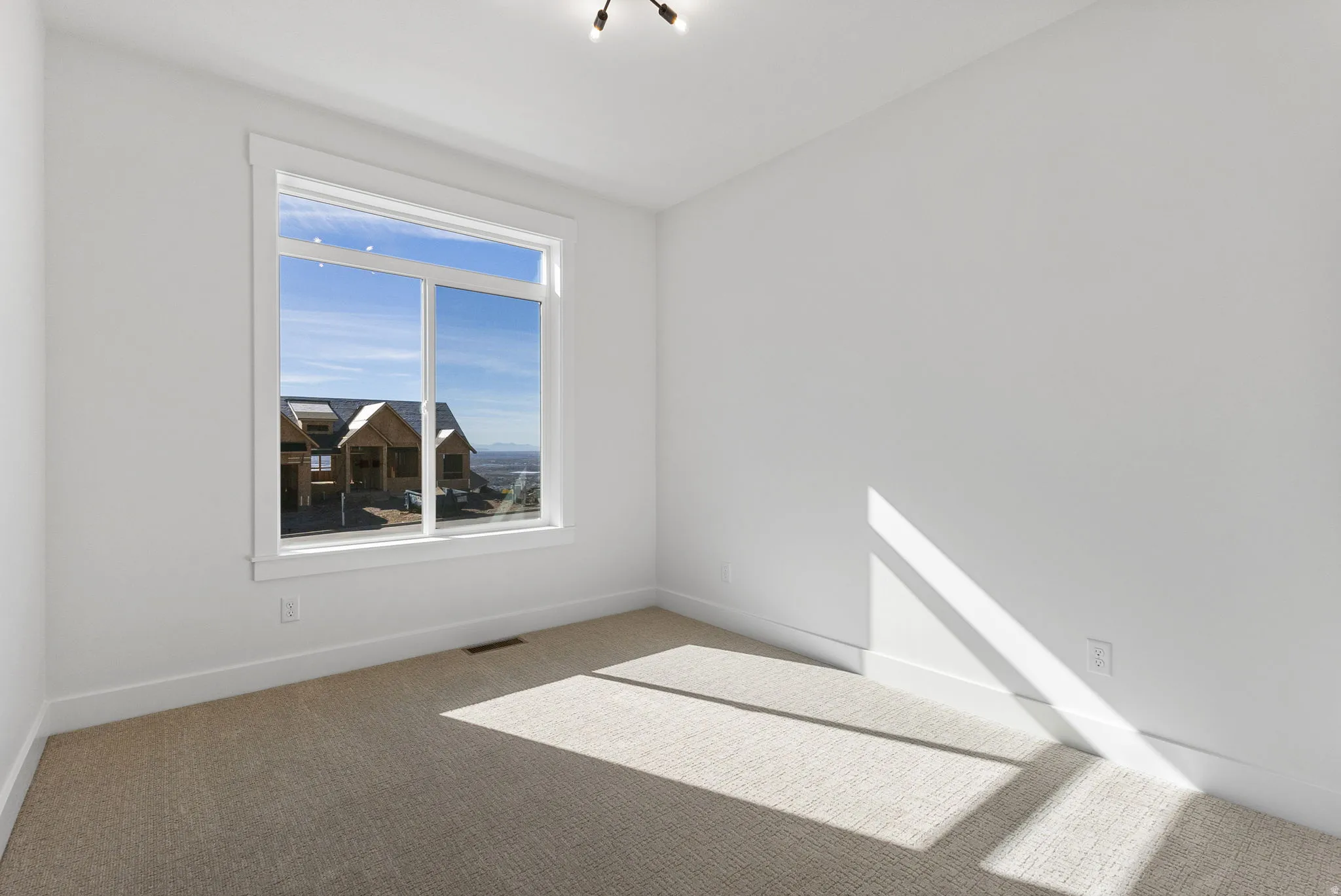 Empty room with carpet and baseboards