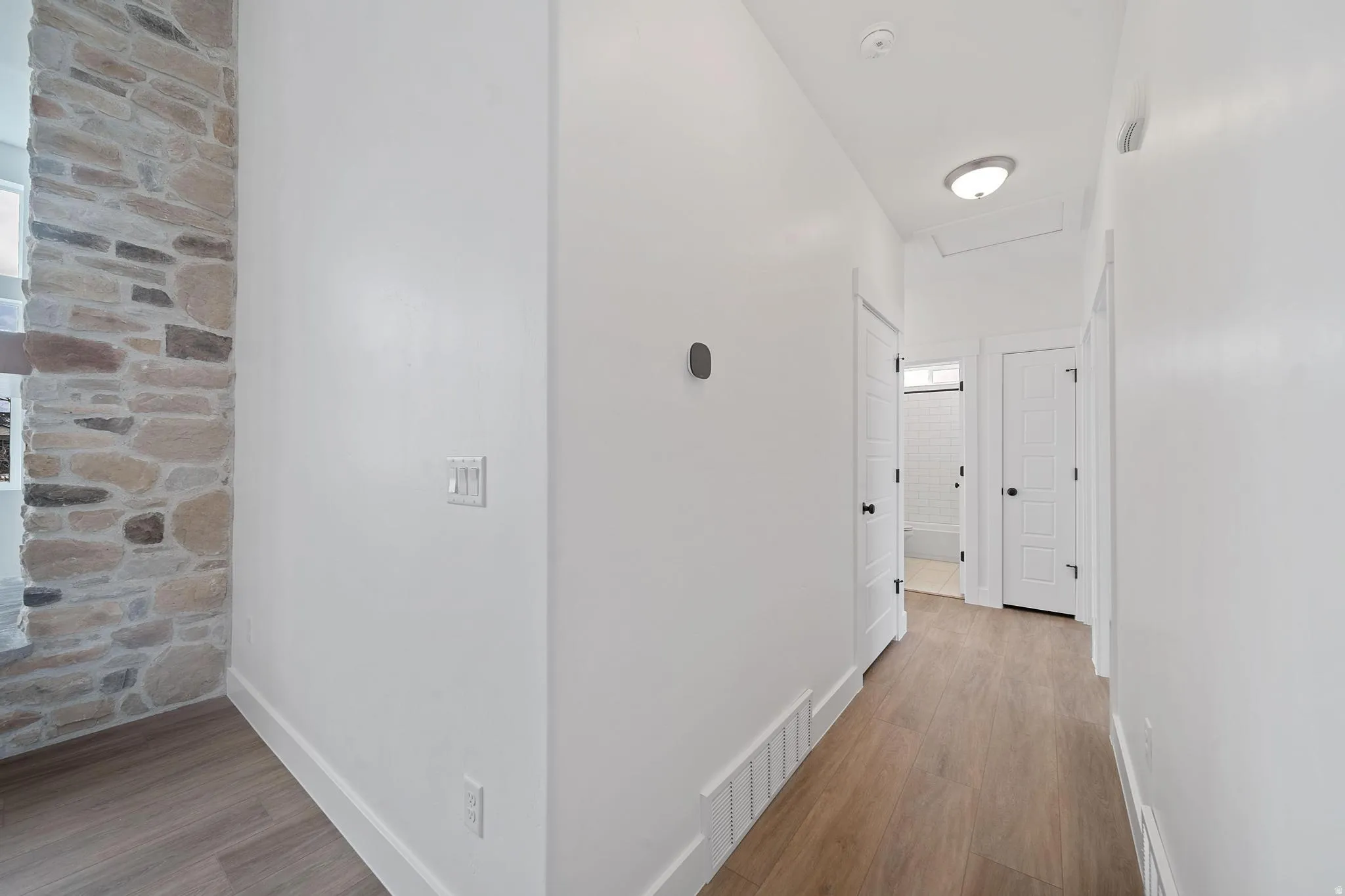 Hallway with light wood-style flooring