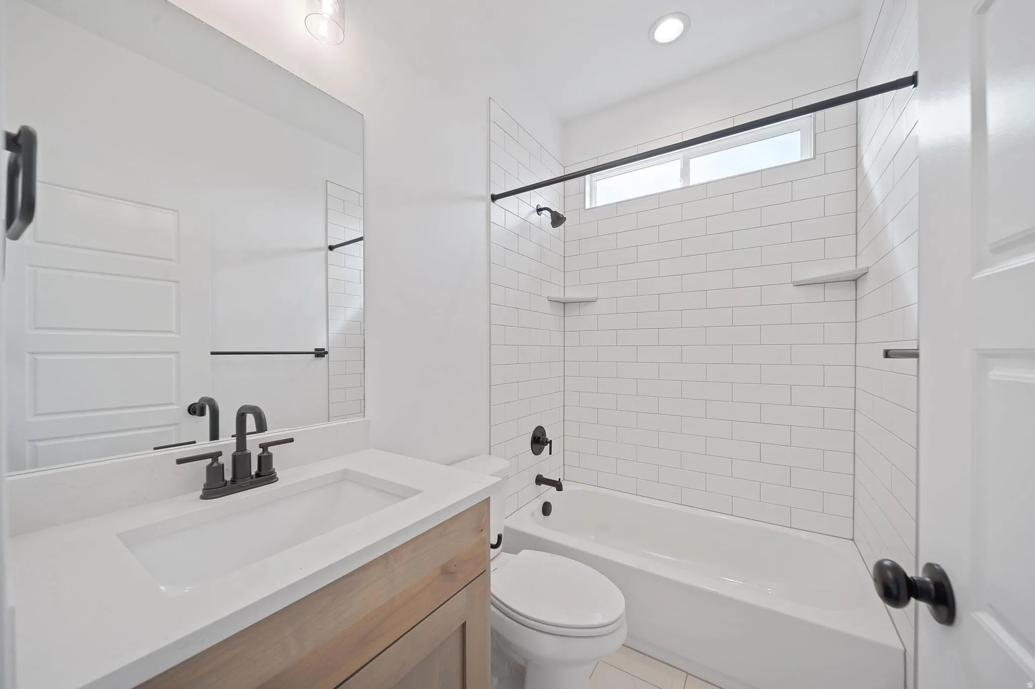 Bathroom featuring vanity and  shower combination