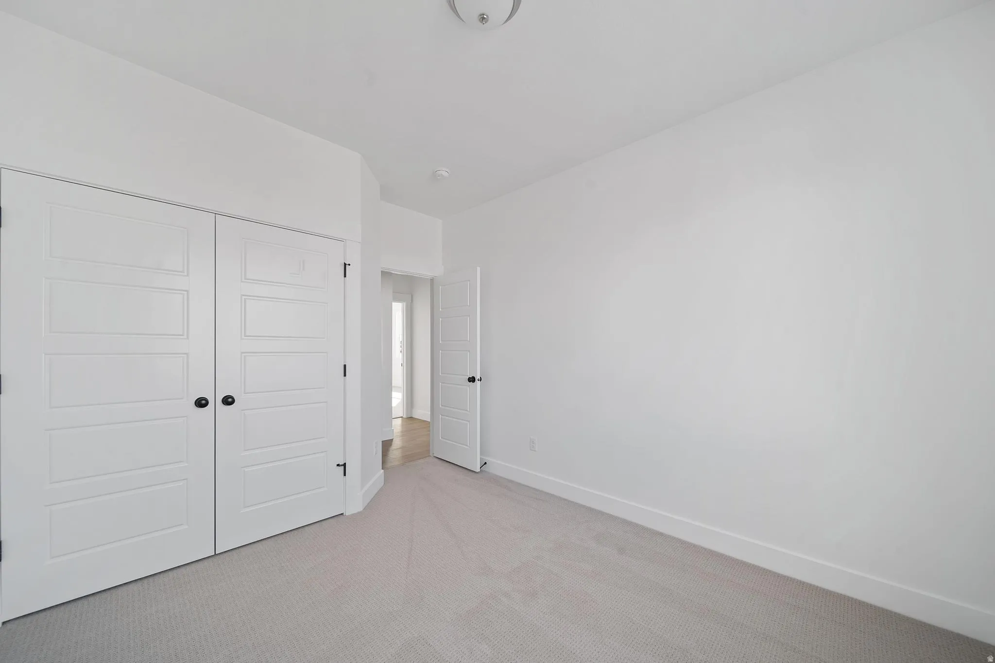 Unfurnished bedroom featuring a closet and carpet flooring
