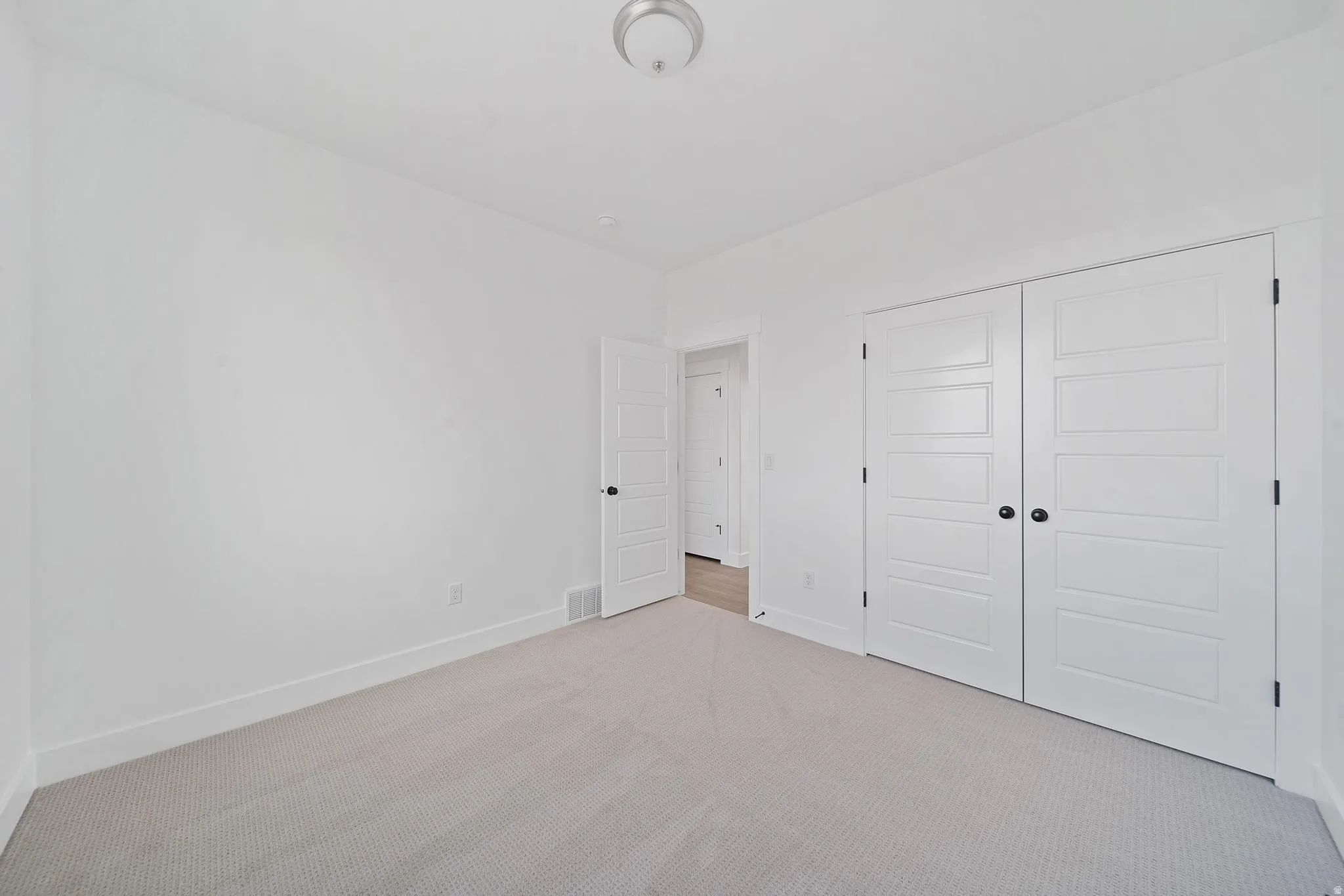 Unfurnished bedroom with carpet floors and a closet