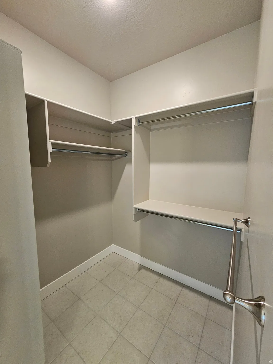 Walk in closet featuring light tile patterned floors