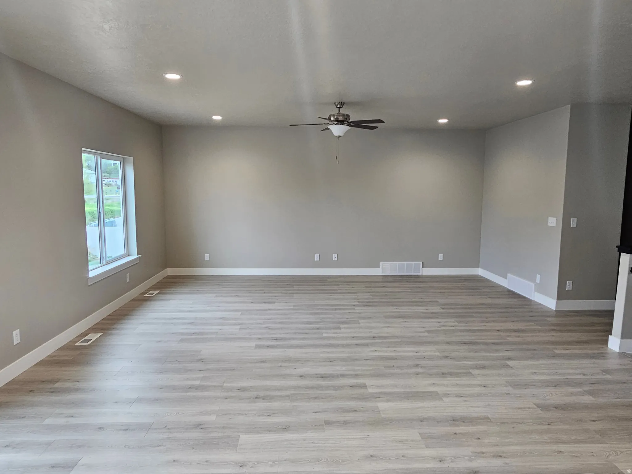 Unfurnished room with recessed lighting, light wood finished floors, and a ceiling fan