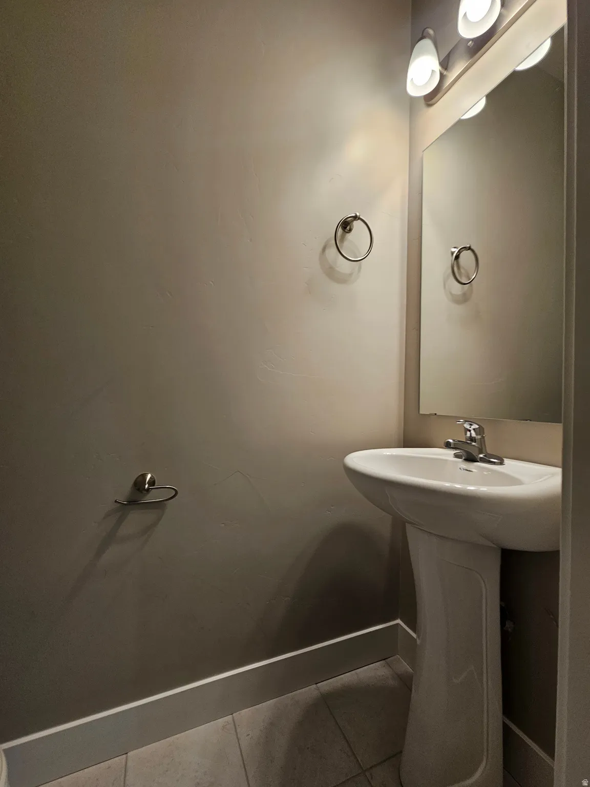 Bathroom featuring tile patterned flooring and baseboards