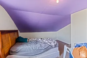 Bedroom featuring vaulted ceiling and carpet floors