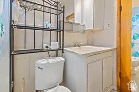 Full bathroom featuring curtained shower and vanity