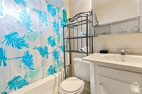 Bathroom featuring shower / tub combo and vanity