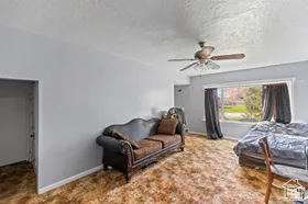 Bedroom featuring ceiling fan and a textured ceiling