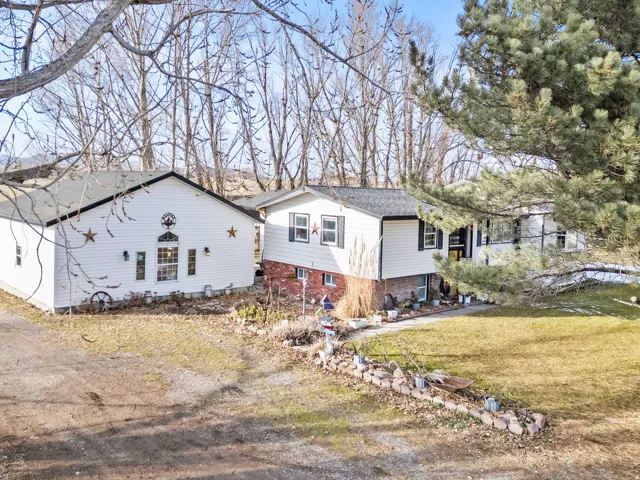 View of property exterior with a yard