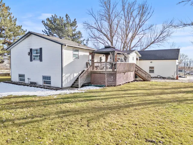 Back of property featuring stairway, a gazebo, a yard, and a deck