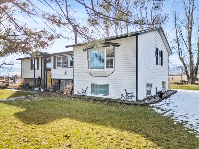 View of side of property with a lawn