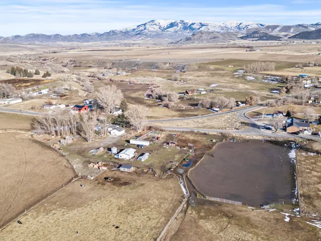 Aerial overview of property's location featuring rural landscape and a mountainous background