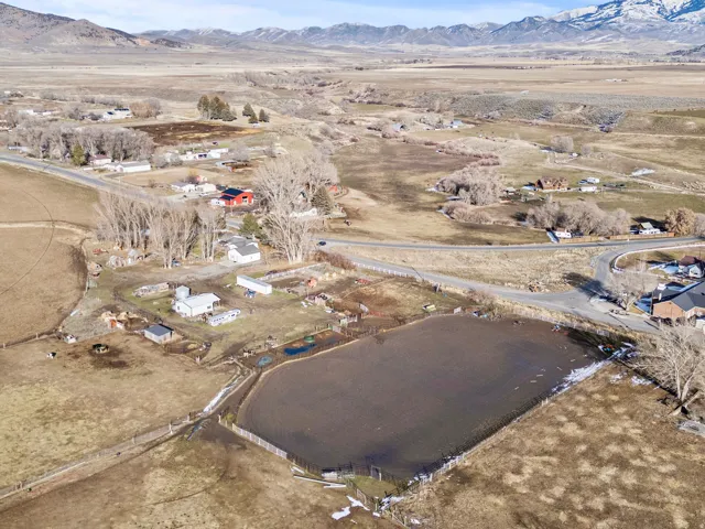 Aerial overview of property's location featuring rural landscape and a mountainous background
