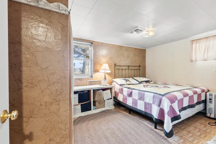 Bedroom featuring parquet flooring