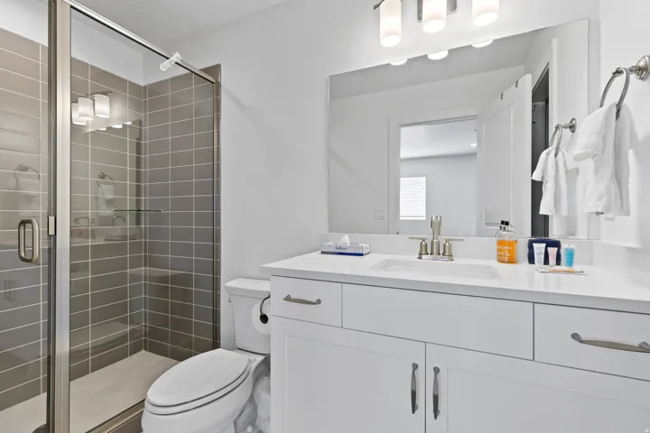 Full bath featuring vanity and a shower stall