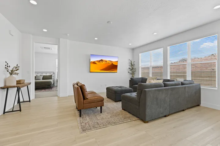 Living area featuring light wood-style flooring and recessed lighting