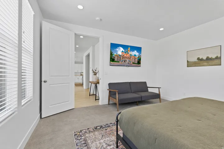 Bedroom with light carpet and recessed lighting