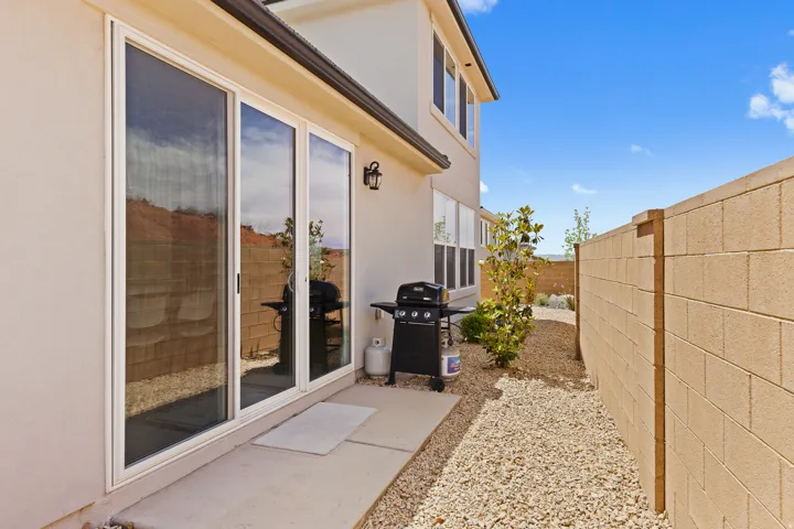 View of side of home with a fenced backyard, a patio area, and stucco siding