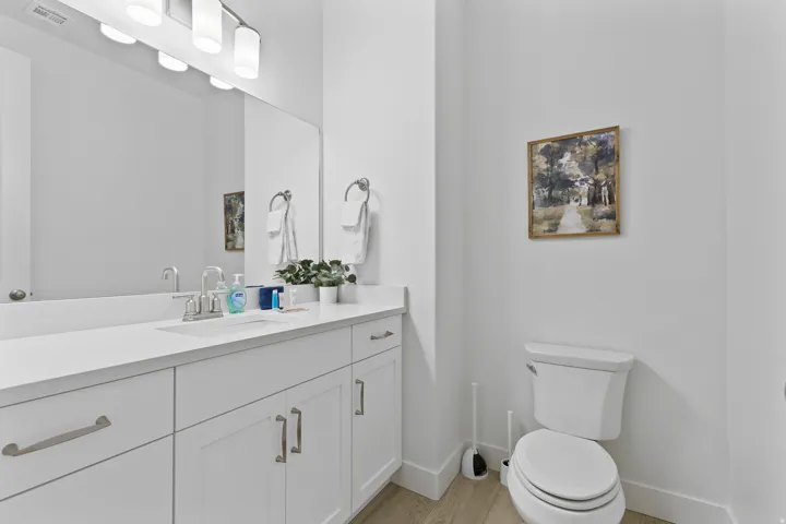 Half bath with vanity and light wood-type flooring