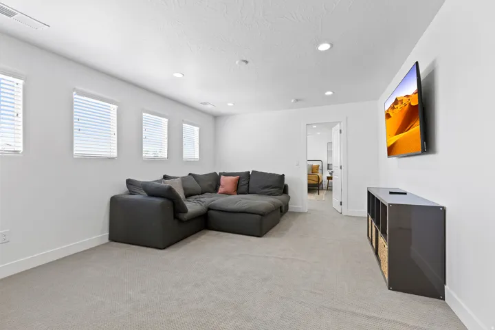 Living room with recessed lighting and light carpet