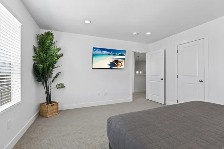 Carpeted bedroom featuring baseboards and recessed lighting