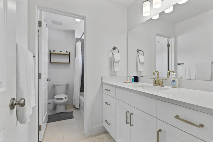Full bathroom featuring vanity, shower / tub combo with curtain, and light tile patterned floors