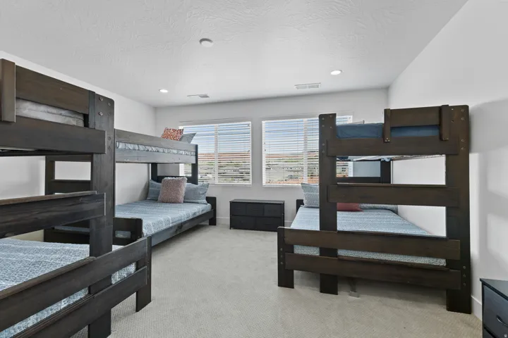 Bedroom with light carpet, a textured ceiling, and recessed lighting