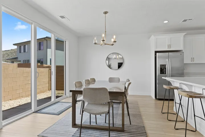 Dining space with a chandelier, light wood-style floors, and recessed lighting
