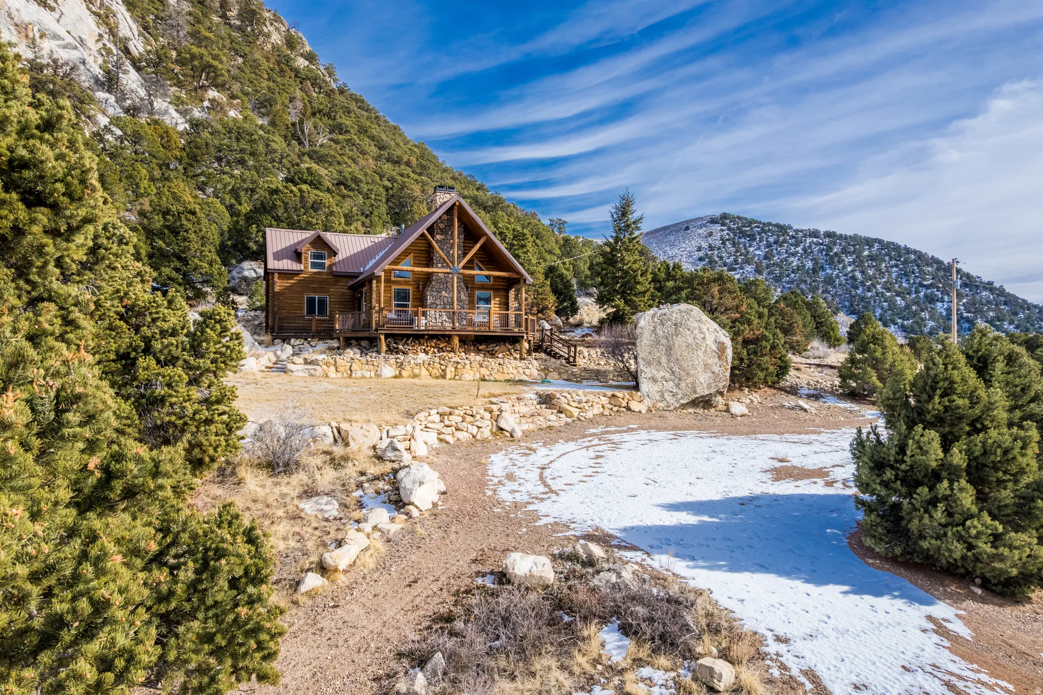 Rear view of property with a metal roof, a chimney, and a deck with mountain view